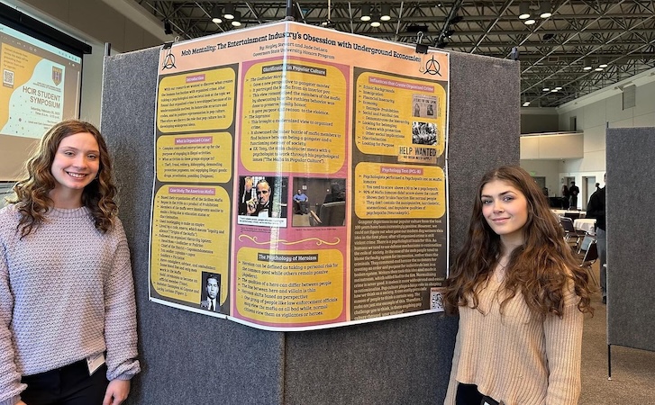 Student in front of poster during Research Day